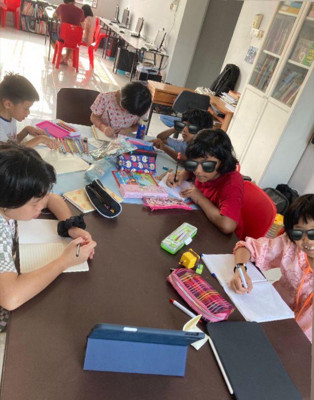 Excellence Academy younger students completing classwork