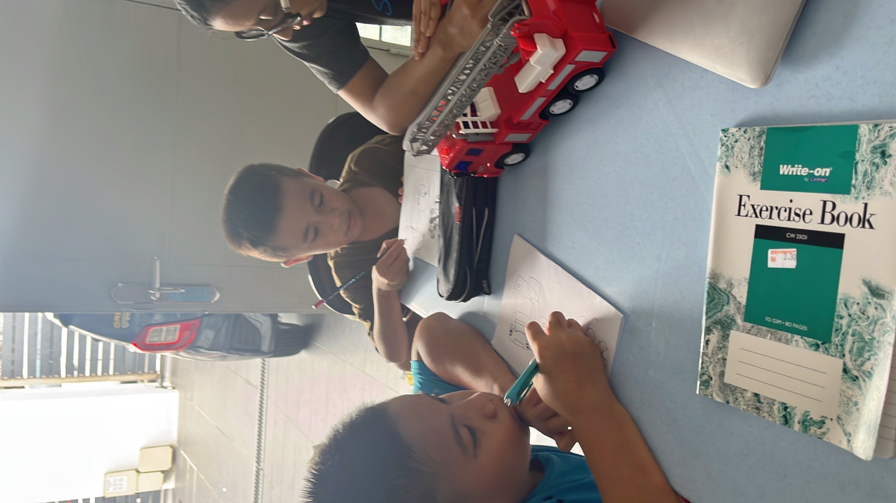 Excellence Academy young learners writing during tuition